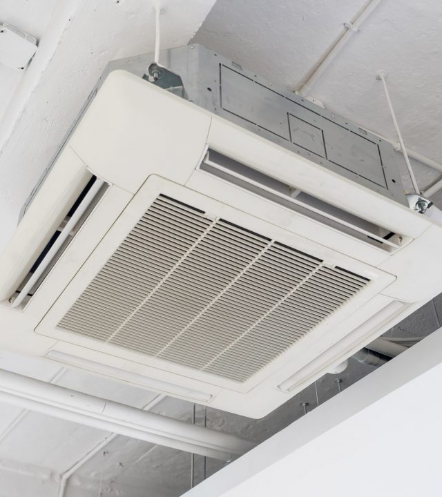 Cassette type air condition with lighting and fire protection system installation on ceiling.
